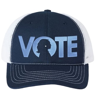 A trucker hat with navy front and white back mash, features the embroidered word Vote. Kamala Harris' profile is inside the letter O, highlighted by a pearl earring.