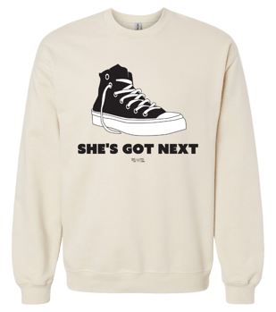 Unisex beige crewneck sweater with a big black and white All Star sneaker illustration and the black bold words beneath it that say "She's Got Next".